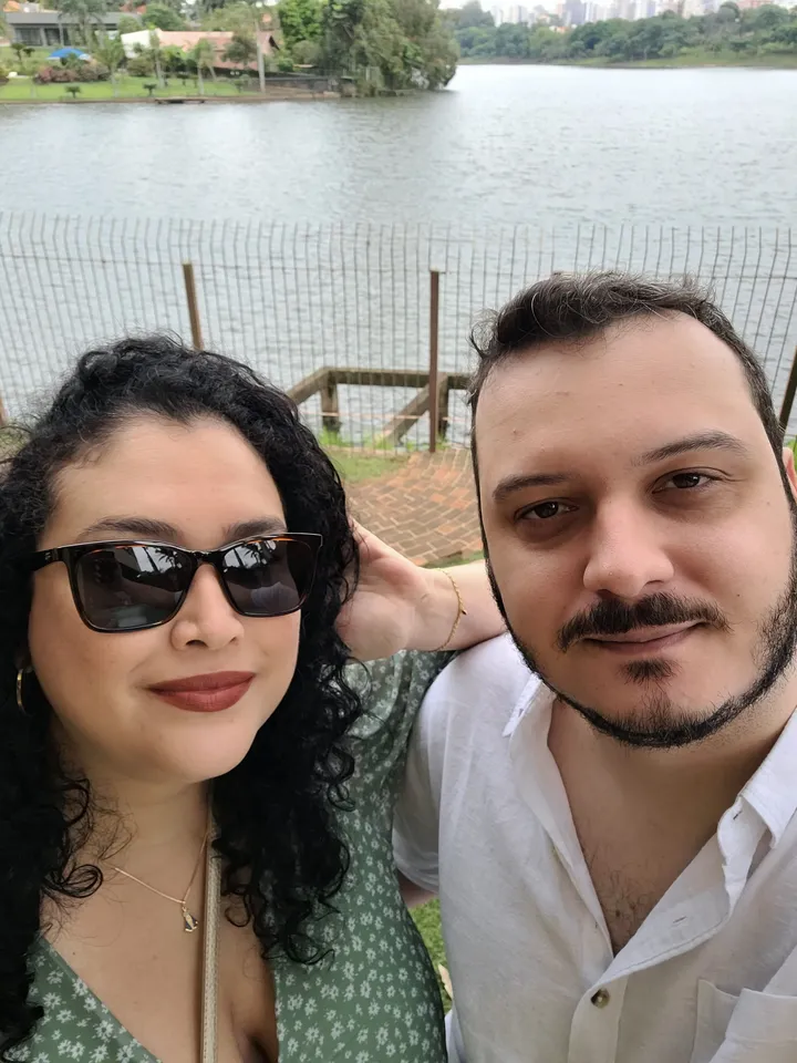 Breno and his wife by a lake